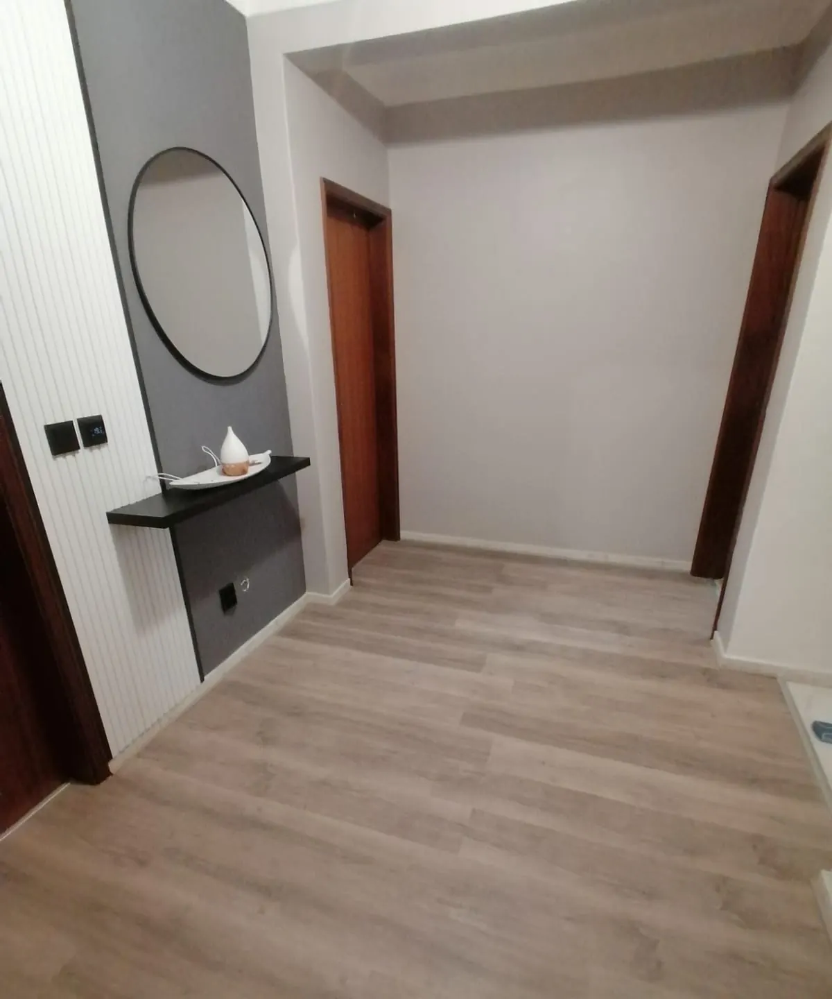 Renovated hallway with slatted feature wall and wood-look flooring